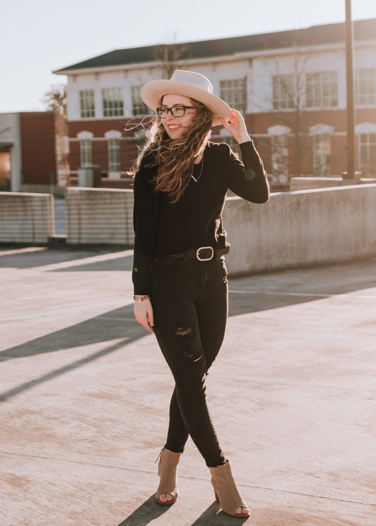 Woman holding hat and looking to the side